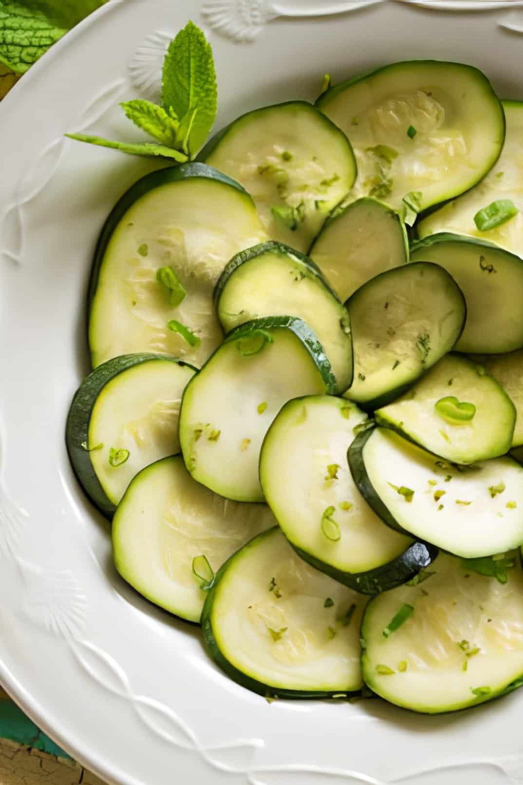 zucchini with mint on a white plate