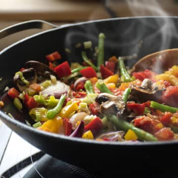 steaming mixed vegetables in the wok, asian style cooking vegetarian and healthy, selected focus, narrow depth of field